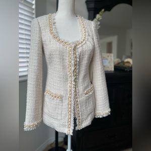 Tweed blazer with gold chain trim.